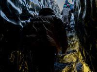 People visit the ice cave on the glacial tongue of Breiðamerkurjökull in Vatnajökull Glacier National Park, Iceland, on January 26, 2023. -V...