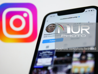 Donald Trump account on Instagram displayed on a phone screen and Instagram logo displayed on a screen in the background are seen in this il...