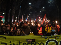 Demonstrators take part in a torchlight procession through the streets of Paris on 26 January 2023 to protest against the French government'...