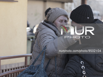Ukrainian old lady arrives in Poland and hugs her relatives while crying. War refugees from Ukraine arrive at Przemysl railway station and g...