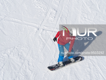 A young man practices snowboarding in the ski and mountain resort of Alto Campoo or Branavieja is located in the municipality of Hermandad d...