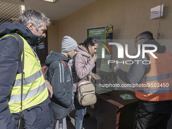 Volunteers give SIM cards with free internet access to the arriving refugees from Ukraine. War refugees from Ukraine arrive at Przemysl rail...