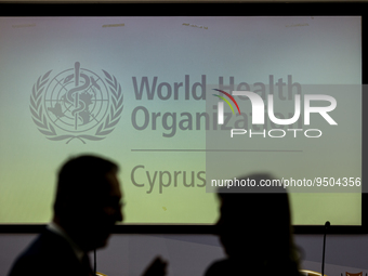 Two silhouettes are seen in front of the WHO logo on the screen, Nicosia, Cyprus, on Jan. 27, 2023. The Signing of an Agreement between the...