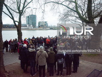 about a hundred people gather in front of  the monument of the memorial to gay and lesbian victims of National Socialism in Cologne, Germany...