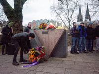 a man placed a wreath at the monument of the memorial to gay and lesbian victims of National Socialism in Cologne, Germany on January 27, 20...