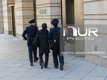 A woman is escorted by U.S. Capitol Police into the E. Barrett Prettyman federal courthouse in Washington, D.C. on January 27, 2023 for the...