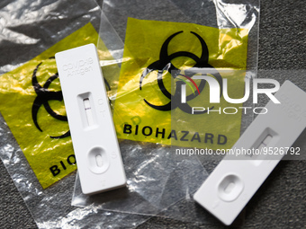 COVID-19 rapid antigen tests and plastic bags with 'biohazard' sign are seen in this illustration photo taken in Krakow, Poland on January 3...