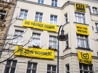 Banners reading 'The houses to those, who live inside them' are seen hanging on a facade of a house in Prenzlauer Berg in Berlin, Germany on...