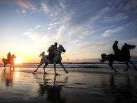 Palestinian men ride on their horses during sunset on Gaza beach, on February 3, 2023.
 (