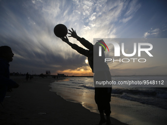 Palestinian boys play along the coast of Gaza City at sunset, on February 5, 2023.  (