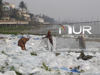 Women work as they dry polythene plastic bags in Dhaka, Bangladesh on February 9, 2023. (