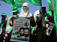 RAMALLAH, PALESTINE -April 30, 2014: Palestinian  girls hold poster for two Hamas members Adil and Imad Awadallah, who was reportedly killed...