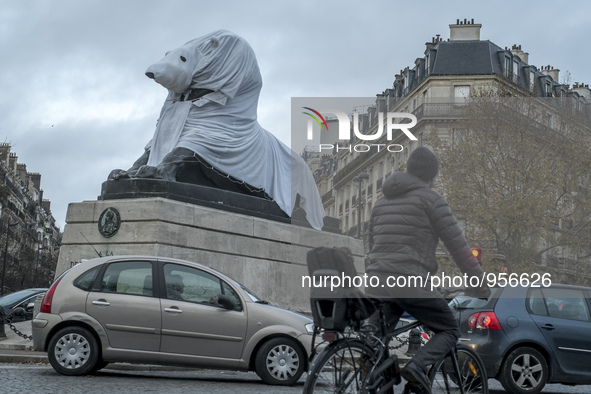 The famous statue of the Lion of Denfert Rochereau square was disguised into a Polar Bear. 2015/12/10. Paris. 