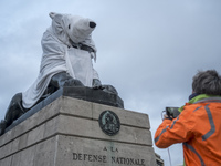 The famous statue of the Lion of Belfort in Denfert Rochereau (14e) square was disguised into a Polar Bear. 2015/12/10. Paris. (