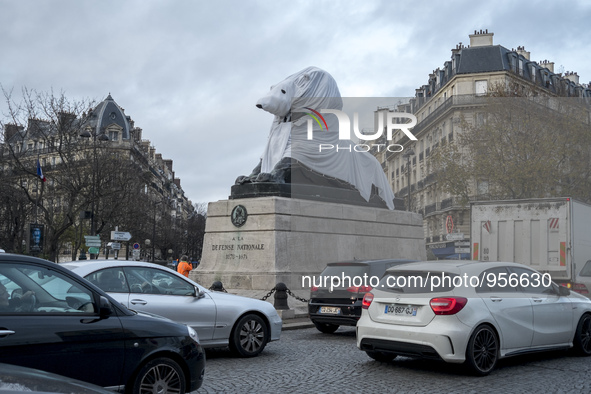 The famous statue of the Lion of Denfert Rochereau square was disguised into a Polar Bear. 2015/12/10. Paris. 