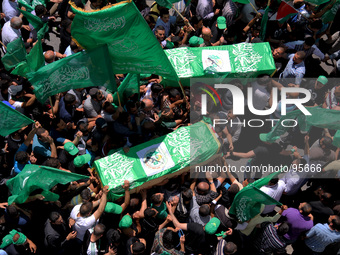 RAMALLAH, PALESTINE -April 30, 2014: Palestinian mourners attend the funeral of the two Hamas members Adel and Imad Awadallah who was report...