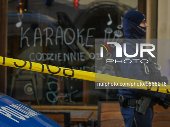 KRAKOW, POLAND - February 09: 
A member of the local Police secures the spot of a deadly shooting at a popular tourist bar in Krakow's Old T...