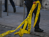 KRAKOW, POLAND - February 09: 
A member of the local Police holds the police tape next to the spot of a deadly shooting at a popular tourist...
