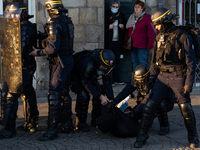 A protester is arrested by French riot police on the sidelines of a demonstration during a demonstration on the fourth day of nationwide ral...