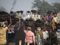 Labor in bangladesh work all day long by unloading coal from cargo.Carrying every basket from cargo to unloading place there have distance a...