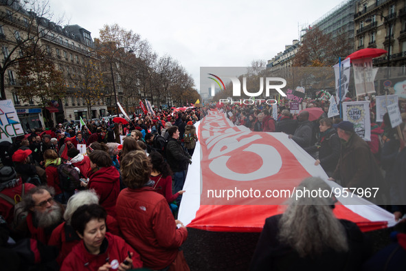 Climate demonstrators hold up a 100 meter long banner during the D12 demonstrations during the last day of COP21 on Avenue De La Grande Armé...