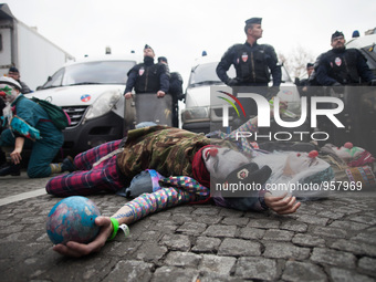 Clowns pretend to die with the planet in front of policemen during the D12 demonstrations during the last day of COP21 on Avenue De La Grand...