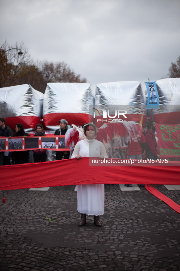 Guardian angel of the climate holds up a red line symbolizing panetary boundries in front of estimated 15,000 demonstrators during the D12 d...