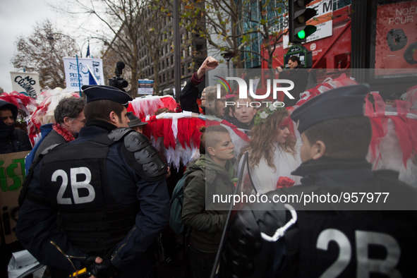 Demonstrators are forced to the side of the street by police during the D12 demonstrations during the last day of COP21 on Avenue De La Gran...