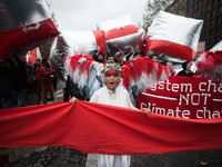 Guardian angels of the climate holds up a red line symbolizing panetary boundries in front of estimated 15,000 demonstrators during the D12...