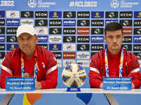 Ruzikul Berdiev, head coach of Uzbekistans FC Nasaf and player Husayn Norchaev attend the press conference ahead of the round of 16 match ag...