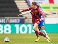 Kieran Dowell #10 of Norwich City tackled by Ryan Nyambe #2 of Wigan Athletic during the Sky Bet Championship match between Wigan Athletic a...