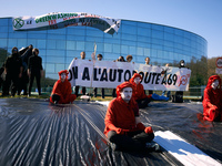 Red Rebels stand on a false highway put on one of the gardens of 'Fabre's headquarters. the banner reads 'No to the A69 highway'. The collec...