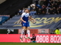 Charlie Wyke #9 of Wigan Athletic in aerial challenge with the opponent during the Sky Bet Championship match between Wigan Athletic and Nor...