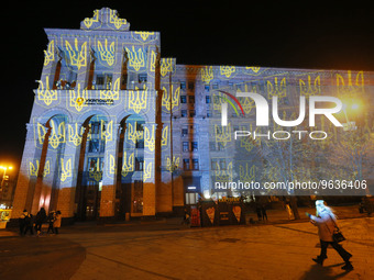 Ukrainians look as the main post office lit up during a light projection by Swiss artist Gerry Hofstetter to commemorate the victims of Russ...