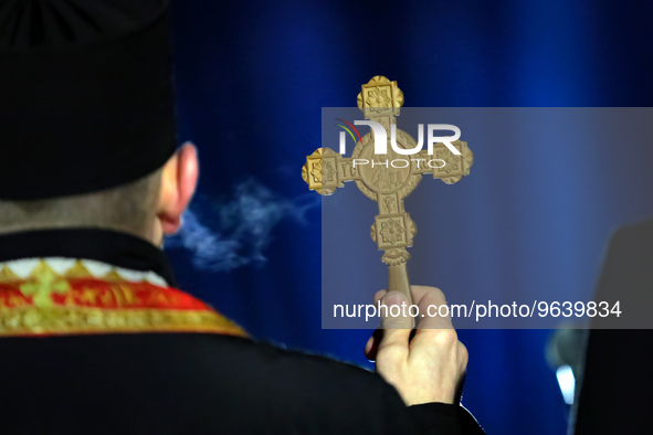 LVIV, UKRAINE - FEBRUARY 23, 2023 - The cross in the hand of a priest during a prayer for the defenders who died in the fight against the Ru...