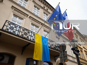 Ukrainian flag is seen hanging next to French and EU flags at Consulate General of the Republic of France, commemorating one-year anniversar...