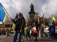 Ukrainian citizens and supporters attend a demonstration of solidarity with Ukraine at the Main Square, commemorating one-year anniversary o...