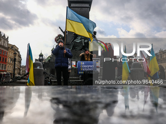Ukrainian citizens and supporters attend a demonstration of solidarity with Ukraine at the Main Square, commemorating one-year anniversary o...
