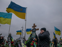 Relatives and friends of killed ukrainian militaries commemorated them on the Alley of Glory at the cemetery in Bucha, one year from beginni...