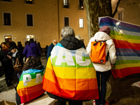 Demonstrators and peace rainbow flags and banner are seen in L'Aquila, Italy, on febraury 24, 2023, during the first anniversary of russian...