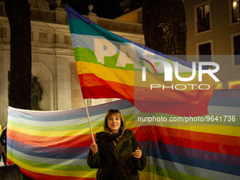 A woman with a peace rainbow flag is seen in L'Aquila, Italy, on febraury 24, 2023, during the first anniversary of russian invasion of Ukra...