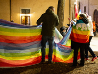 Demonstrators and peace rainbow flags and banner are seen in L'Aquila, Italy, on febraury 24, 2023, during the first anniversary of russian...