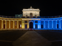 A view of monument Emiciclo palace (Abruzzo regional council headquarter) colored with Ukrain flag colors (yellow and blue) is seen in L'Aqu...