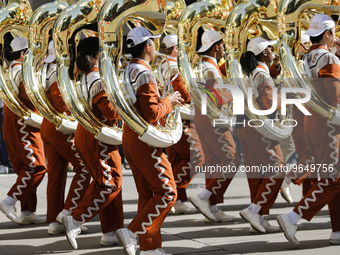 The University of Texas Marching Band walks down Walker Street in the parade on February 25, 2023.  (