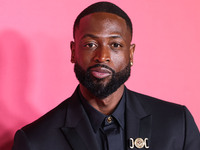 American former professional basketball player Dwyane Wade, recipient of the President's Award wearing Versace poses in the press room at th...