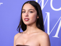Olivia Rodrigo wearing a Jacquemus dress, Giuseppe Zanotti shoes, and Tyler Ellis clutch arrives at the 2023 Billboard Women In Music held a...