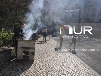 

People are seen walking near a chestnut seller located in one of the streets of the historic area of Sintra, Portugal, on March 3rd, 2023....