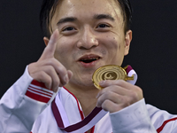 Gold medalist Yang Liu of China poses during the awarding ceremony after the mens Rings final at the 15th FIG Artistic Gymnastics World Cup...