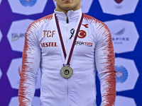 silver medalist Adem Asil of Turkey  poses during the awarding ceremony after the mens Rings final at the 15th FIG Artistic Gymnastics World...