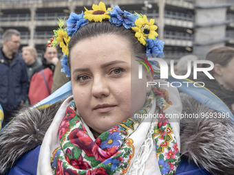 A young woman with a flower wreath and the flag of Ukraine in her shoulder. Hundreds of Ukrainians and Dutch people embarked on the Walk of...